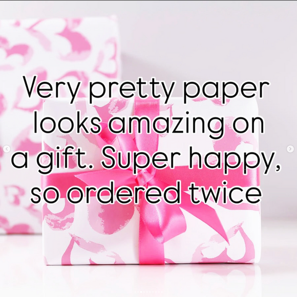 Pink heart paper on a gift with text overlay with a good review